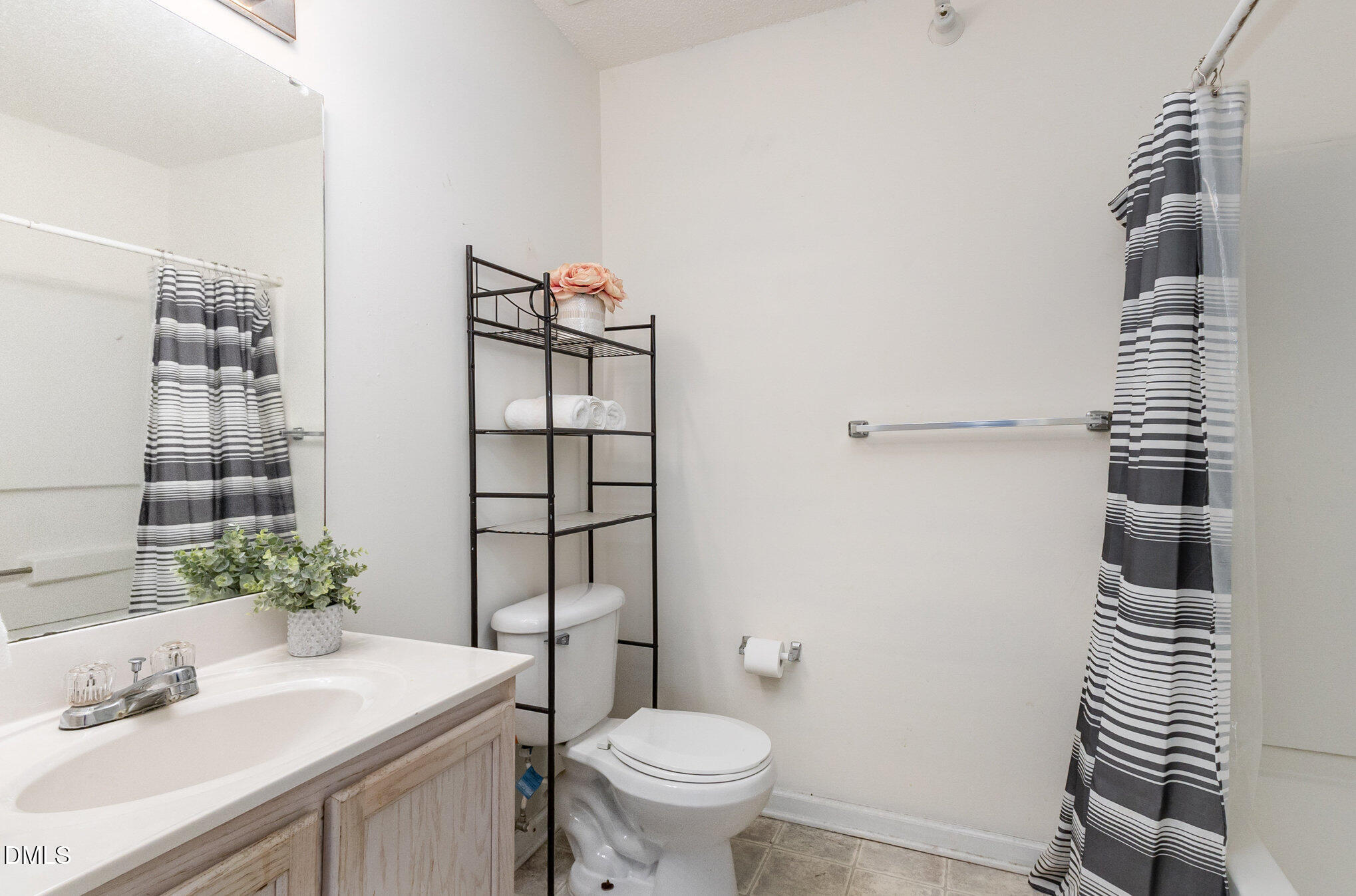 2011 Wolfmill Drive, Unit 301 Raleigh, NC 27603 - Photo 7 of 12 a bathroom with a sink toilet and shower