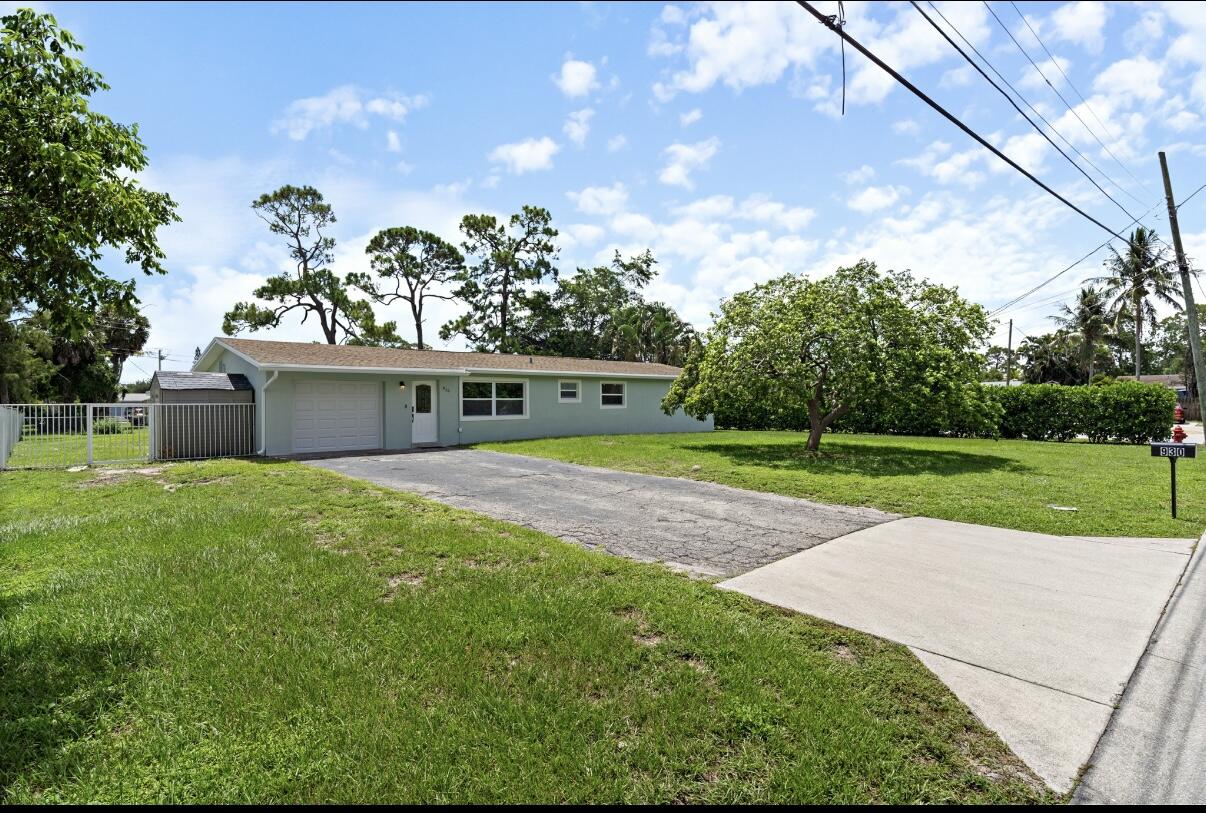 930 Rutherford Lane Haverhill, FL 33415 - Photo 1 of 25 a front view of a house with a yard