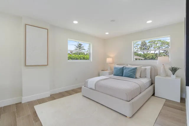 a bedroom with a bed and a painting on the wall