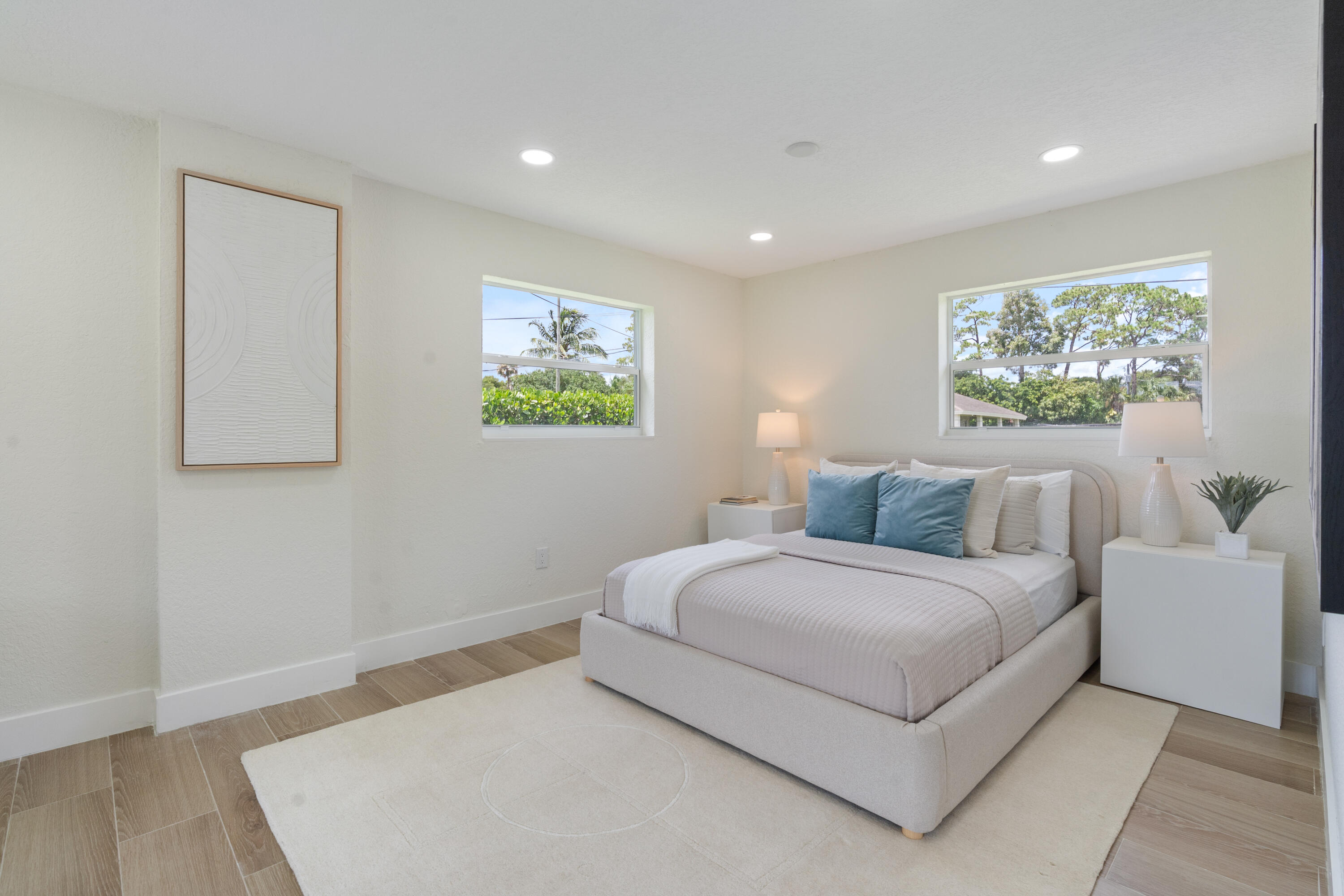 930 Rutherford Lane Haverhill, FL 33415 - Photo 18 of 25 a bedroom with a bed and a painting on the wall