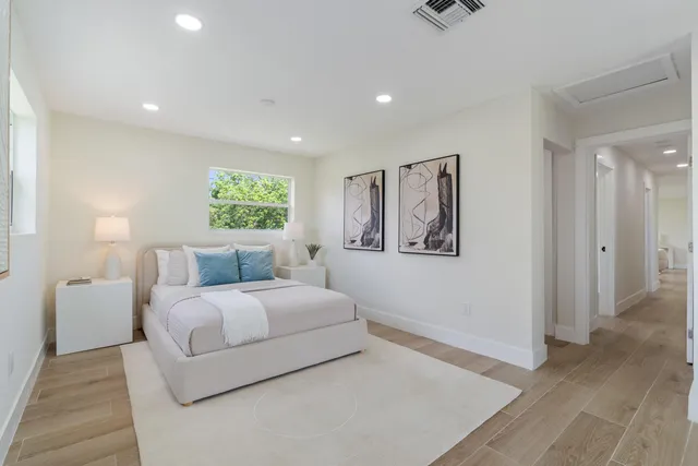 a bedroom with a large bed and a chandelier