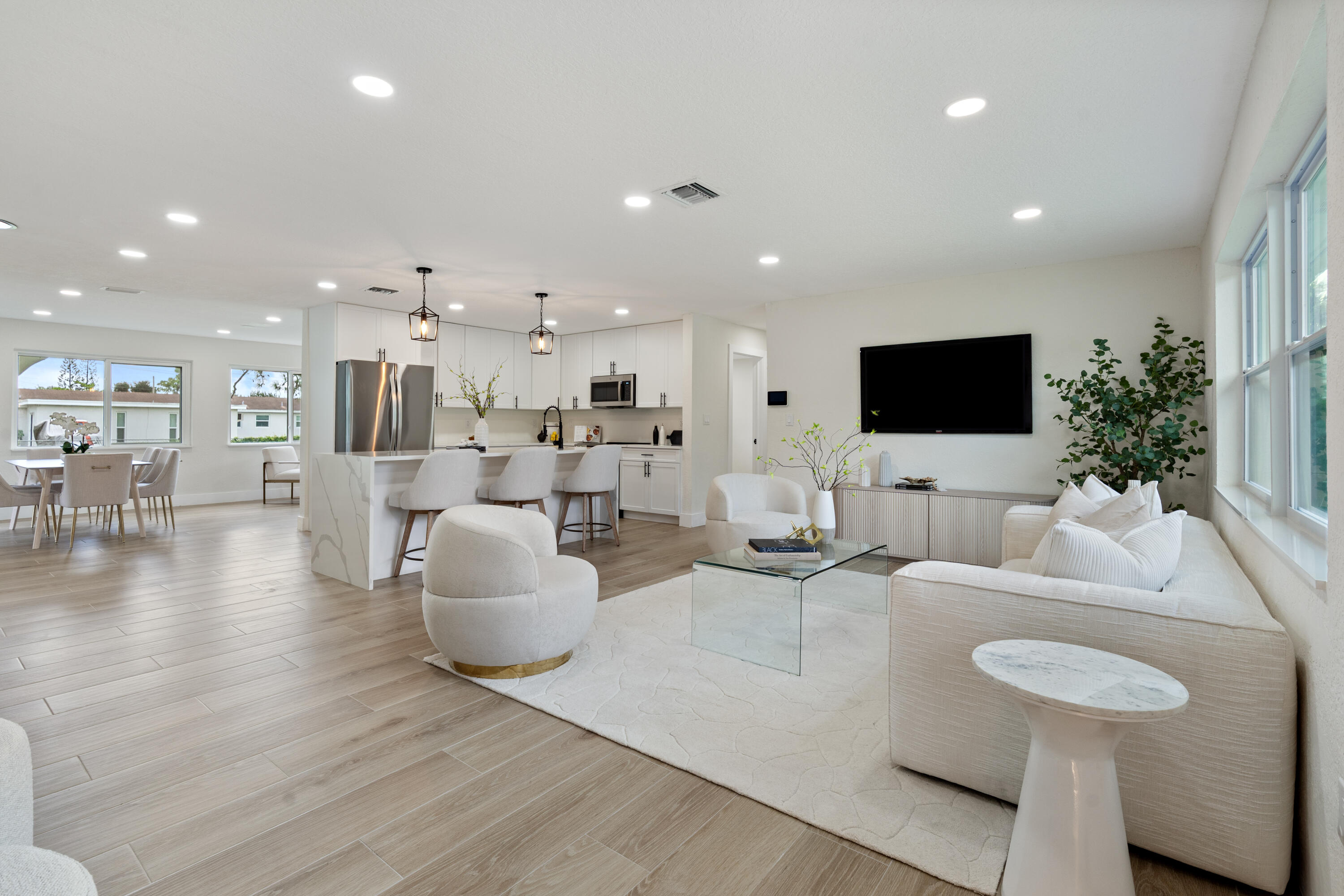 930 Rutherford Lane Haverhill, FL 33415 - Photo 2 of 25 a living room with furniture and a flat screen tv