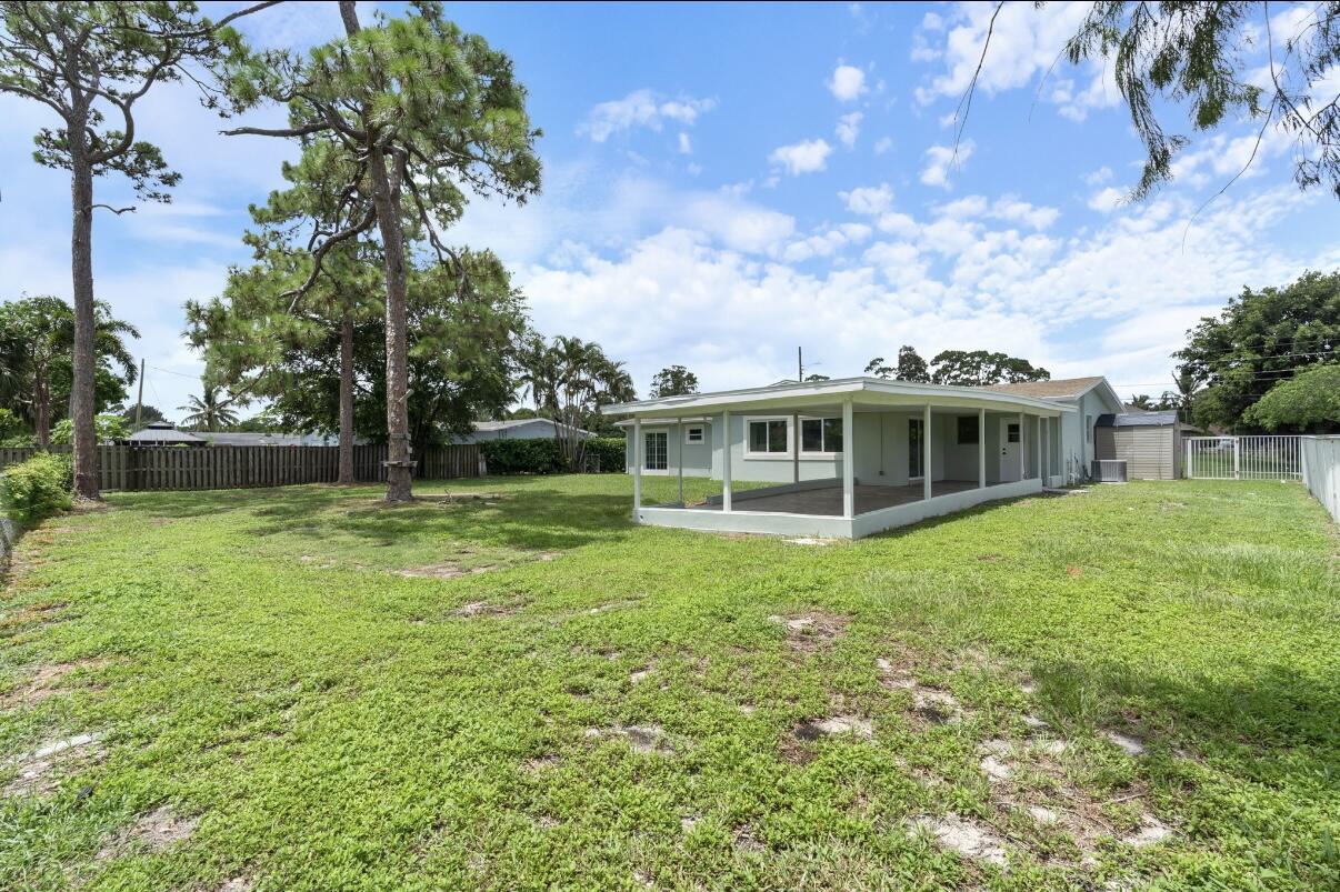 930 Rutherford Lane Haverhill, FL 33415 - Photo 24 of 25 a view of a house with a big yard