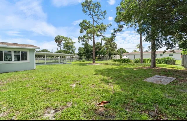 a garden with trees in front of it