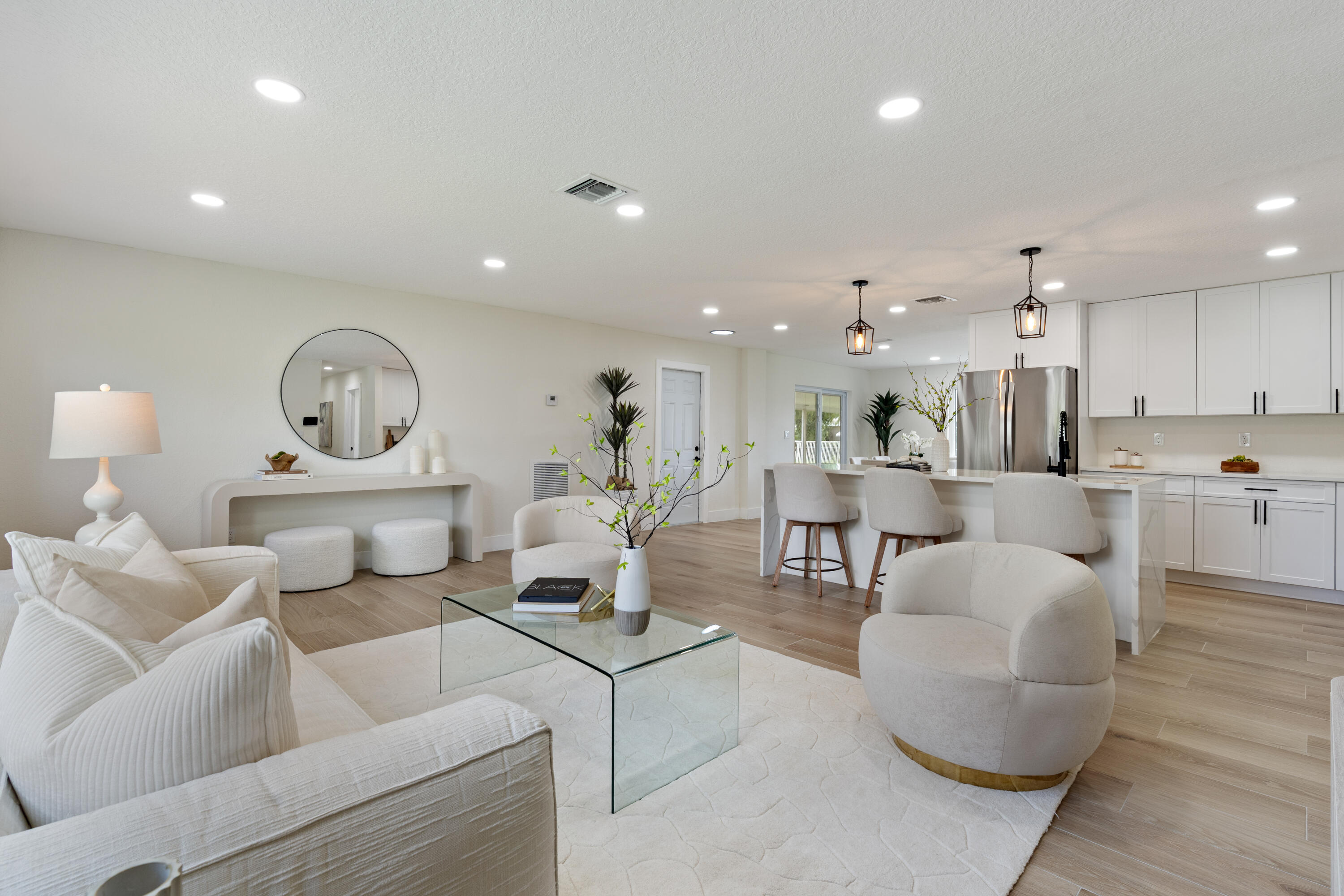 930 Rutherford Lane Haverhill, FL 33415 - Photo 3 of 25 a living room with furniture and a wooden floor