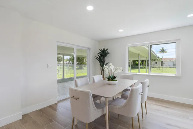 a view of a dining room with furniture and window