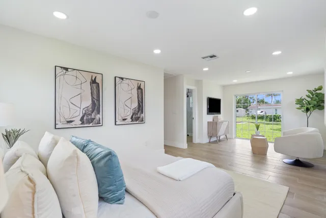 a spacious bedroom with a bed and couch