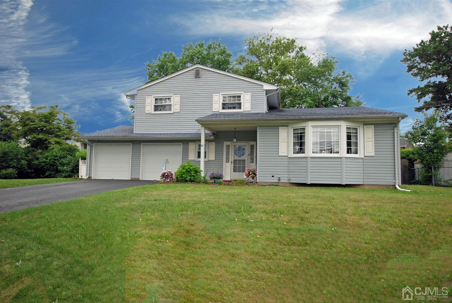 61 Greenbrook Road Middlesex, NJ 08846 - Photo 1 of 29 a front view of a house with a garden