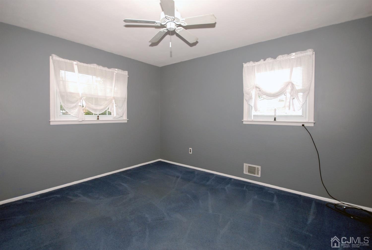 61 Greenbrook Road Middlesex, NJ 08846 - Photo 18 of 29 an empty room with windows and fan