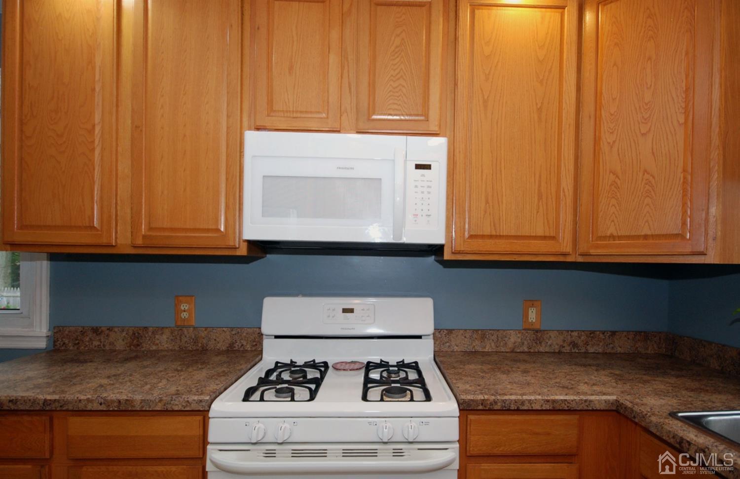61 Greenbrook Road Middlesex, NJ 08846 - Photo 21 of 29 a kitchen with granite countertop wood cabinets and stainless steel appliances