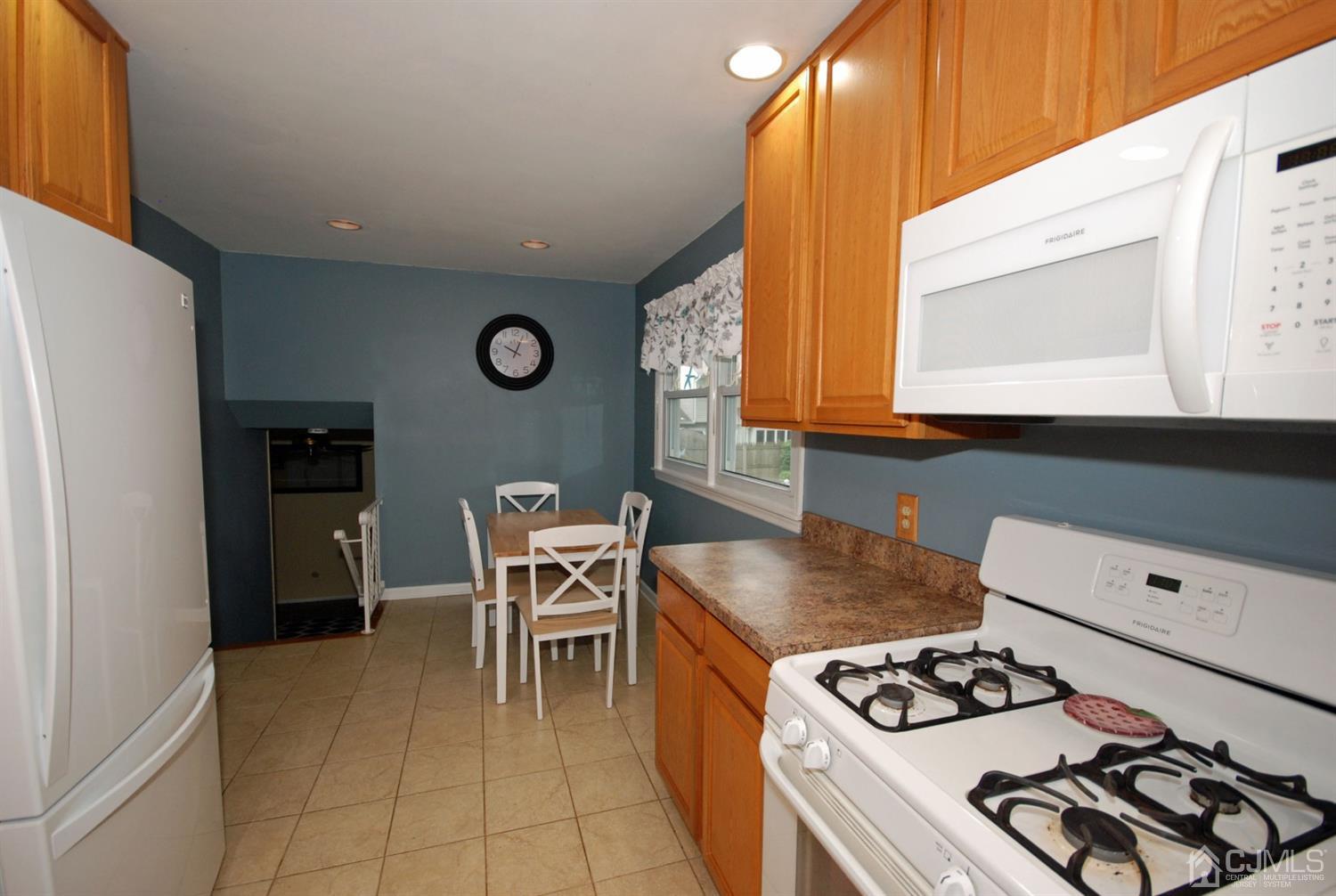 61 Greenbrook Road Middlesex, NJ 08846 - Photo 22 of 29 a kitchen with stainless steel appliances granite countertop a stove a sink and a microwave