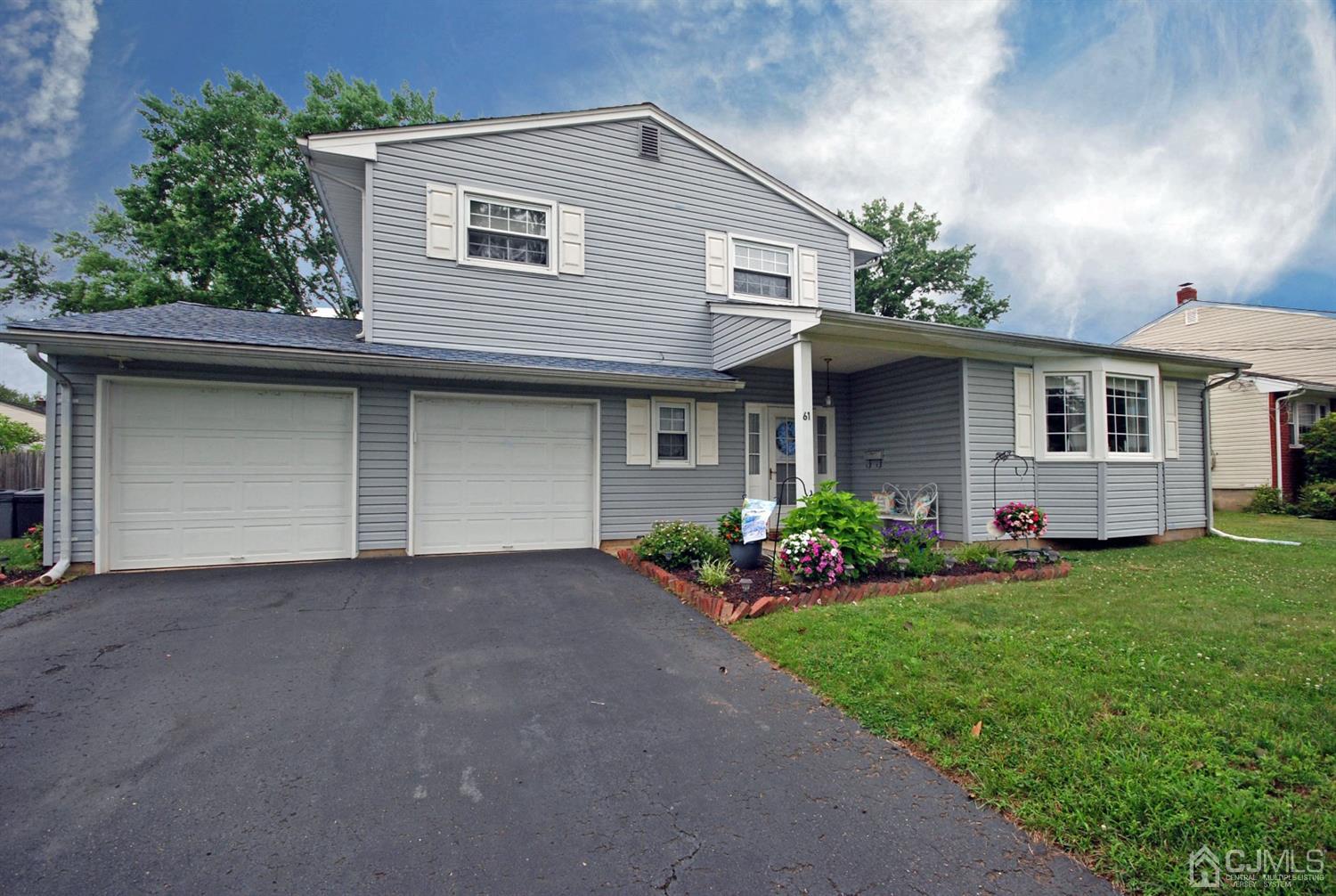 61 Greenbrook Road Middlesex, NJ 08846 - Photo 25 of 29 a front view of a house with a garden and yard