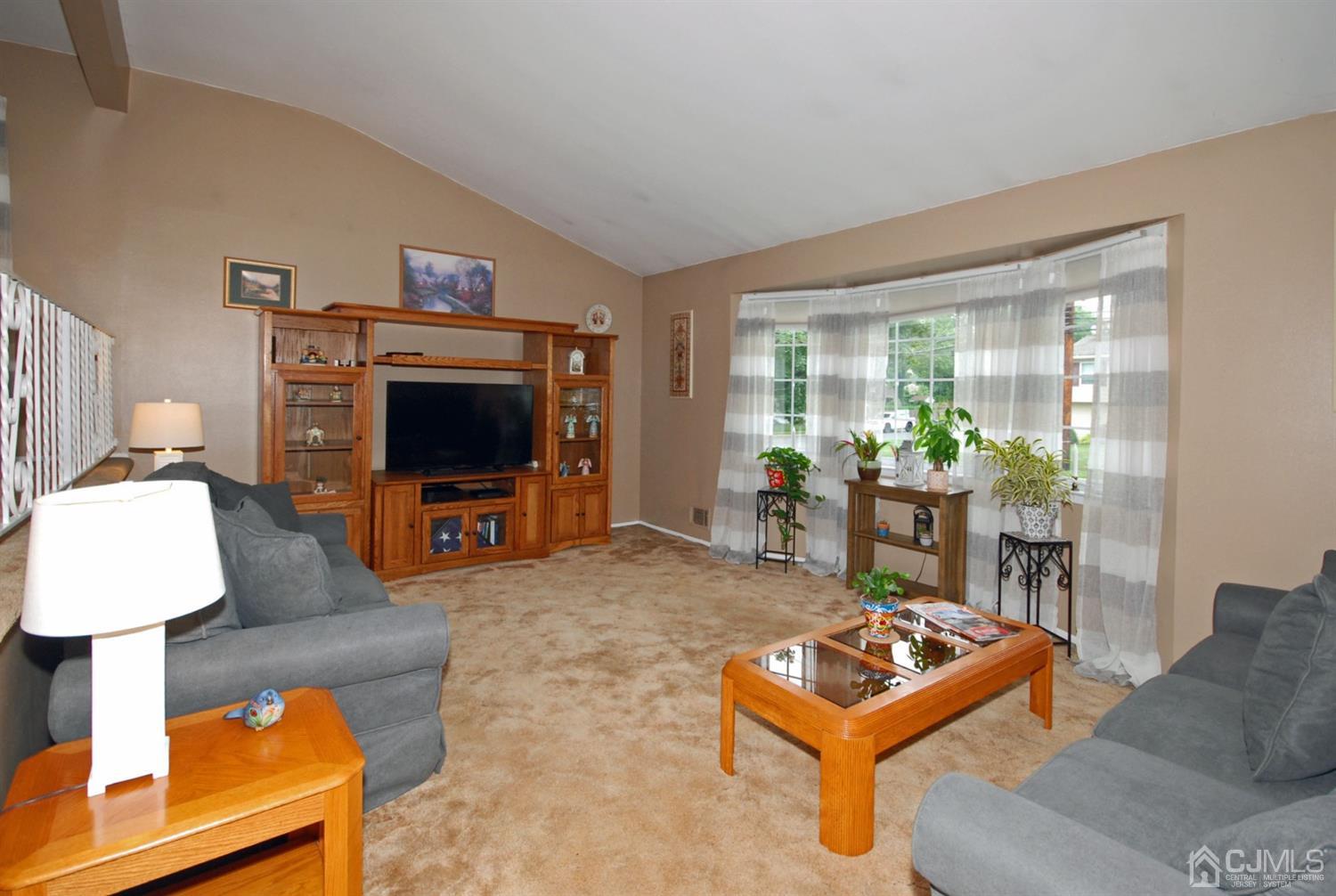 61 Greenbrook Road Middlesex, NJ 08846 - Photo 4 of 29 a living room with furniture and a flat screen tv