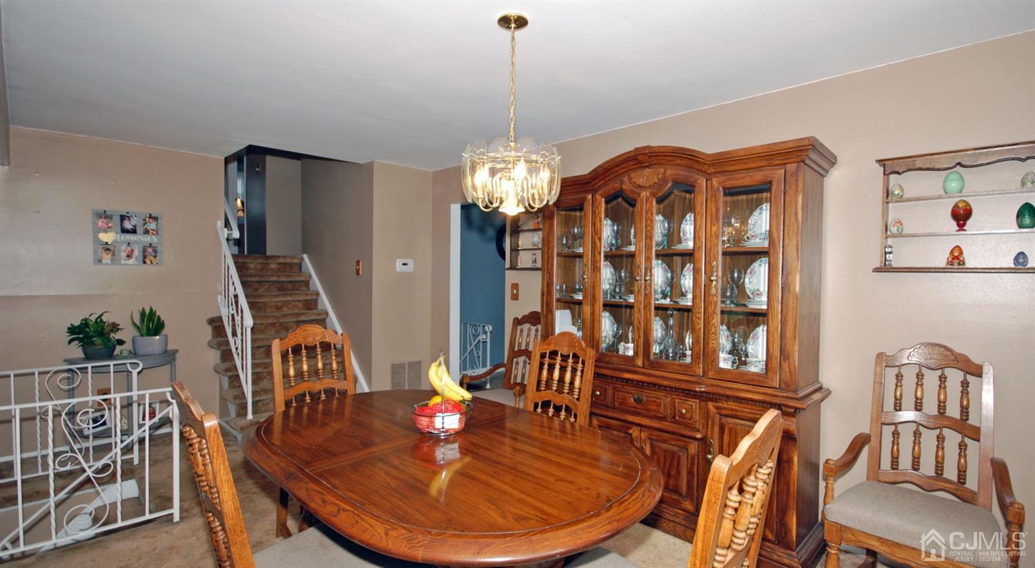 61 Greenbrook Road Middlesex, NJ 08846 - Photo 6 of 29 a dining room with furniture a chandelier and wooden floor
