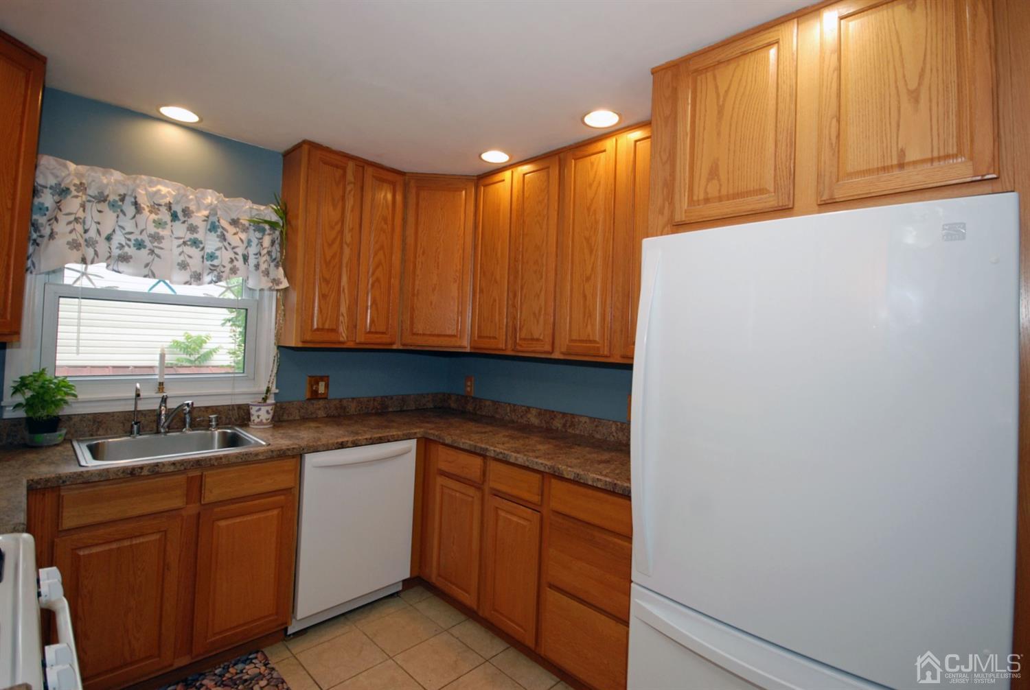 61 Greenbrook Road Middlesex, NJ 08846 - Photo 7 of 29 a kitchen with a sink and cabinets