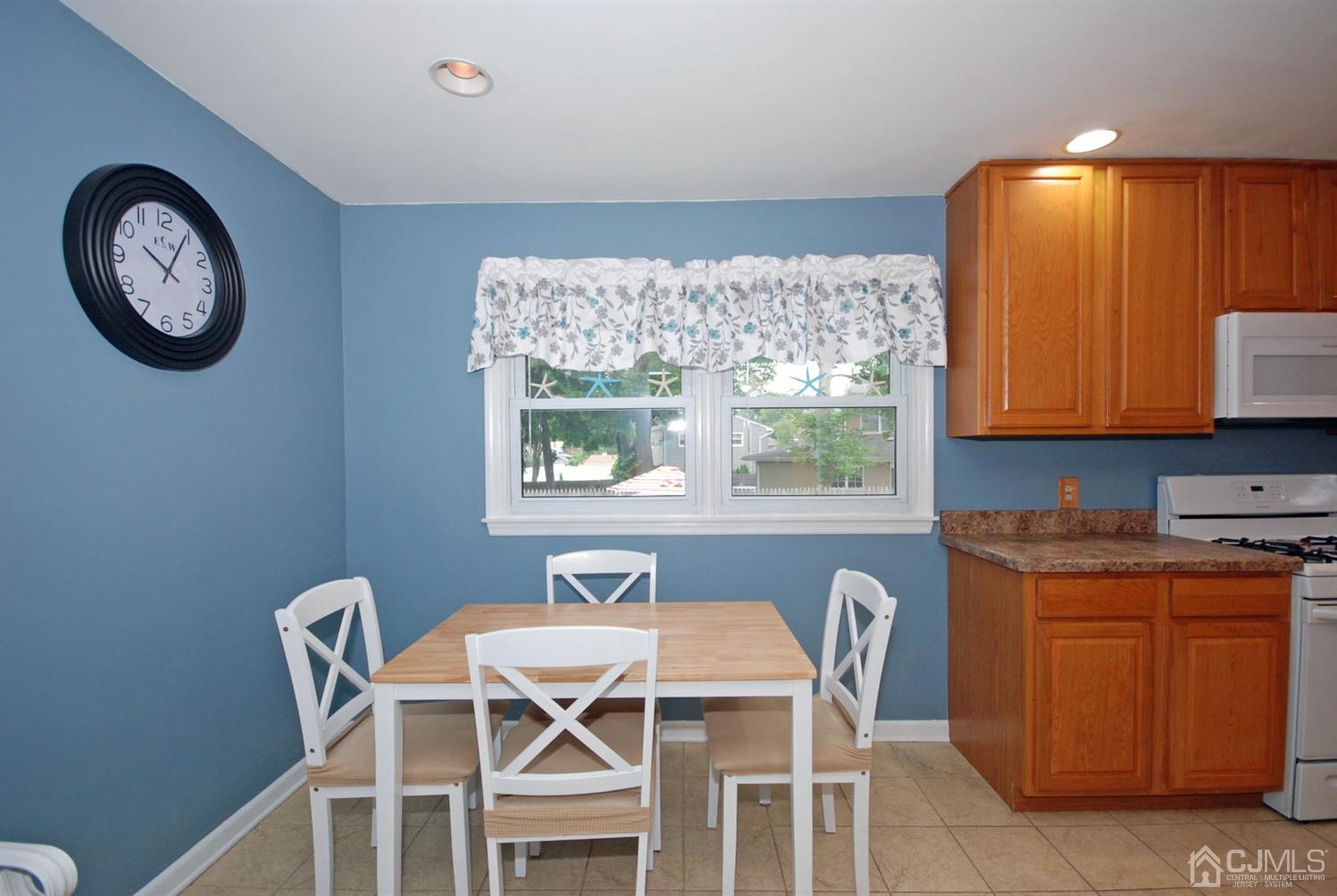61 Greenbrook Road Middlesex, NJ 08846 - Photo 8 of 29 a table and chairs in a room