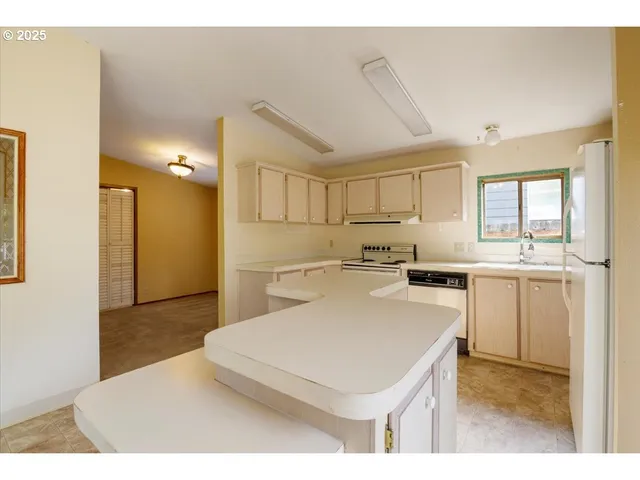 a kitchen that has a sink and a stove in it