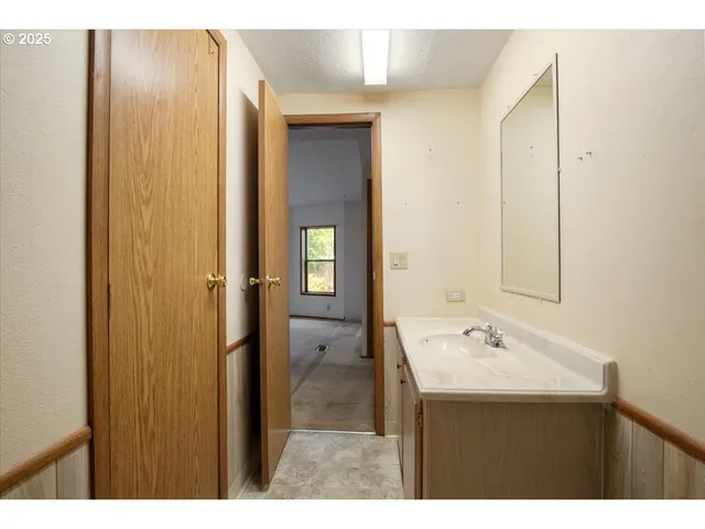 a bathroom with a sink vanity and a mirror