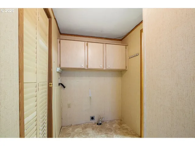 an empty room with windows and closet