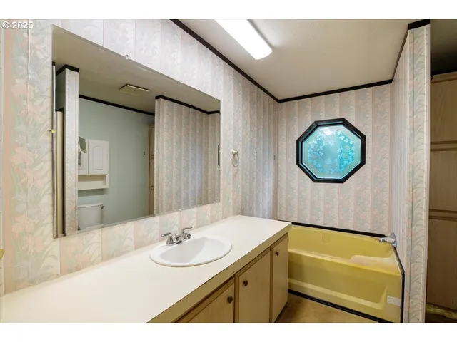 a bathroom with a sink and mirror