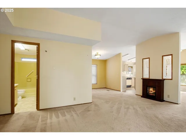 a view of an empty room with a fireplace