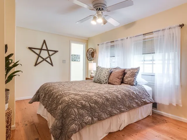 a bedroom with a bed and ceiling fan