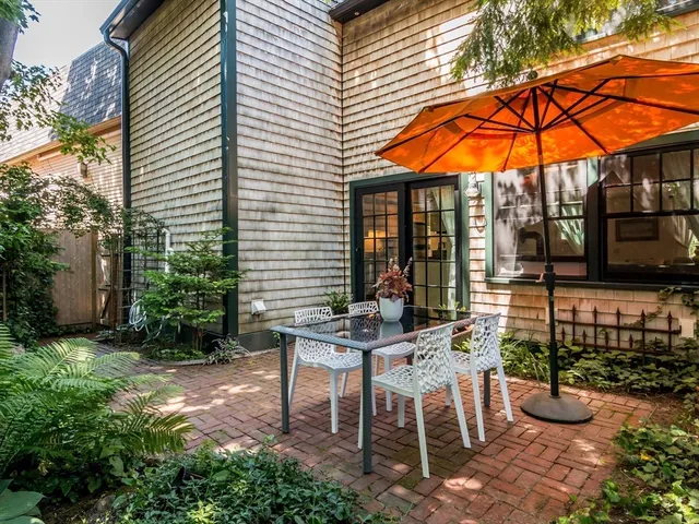a view of an outdoor sitting area with brick walls