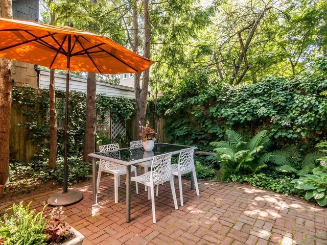 a patio with a yard table and chairs