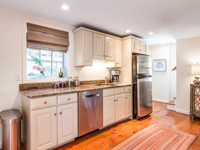 a kitchen with stainless steel appliances granite countertop a refrigerator sink and cabinets