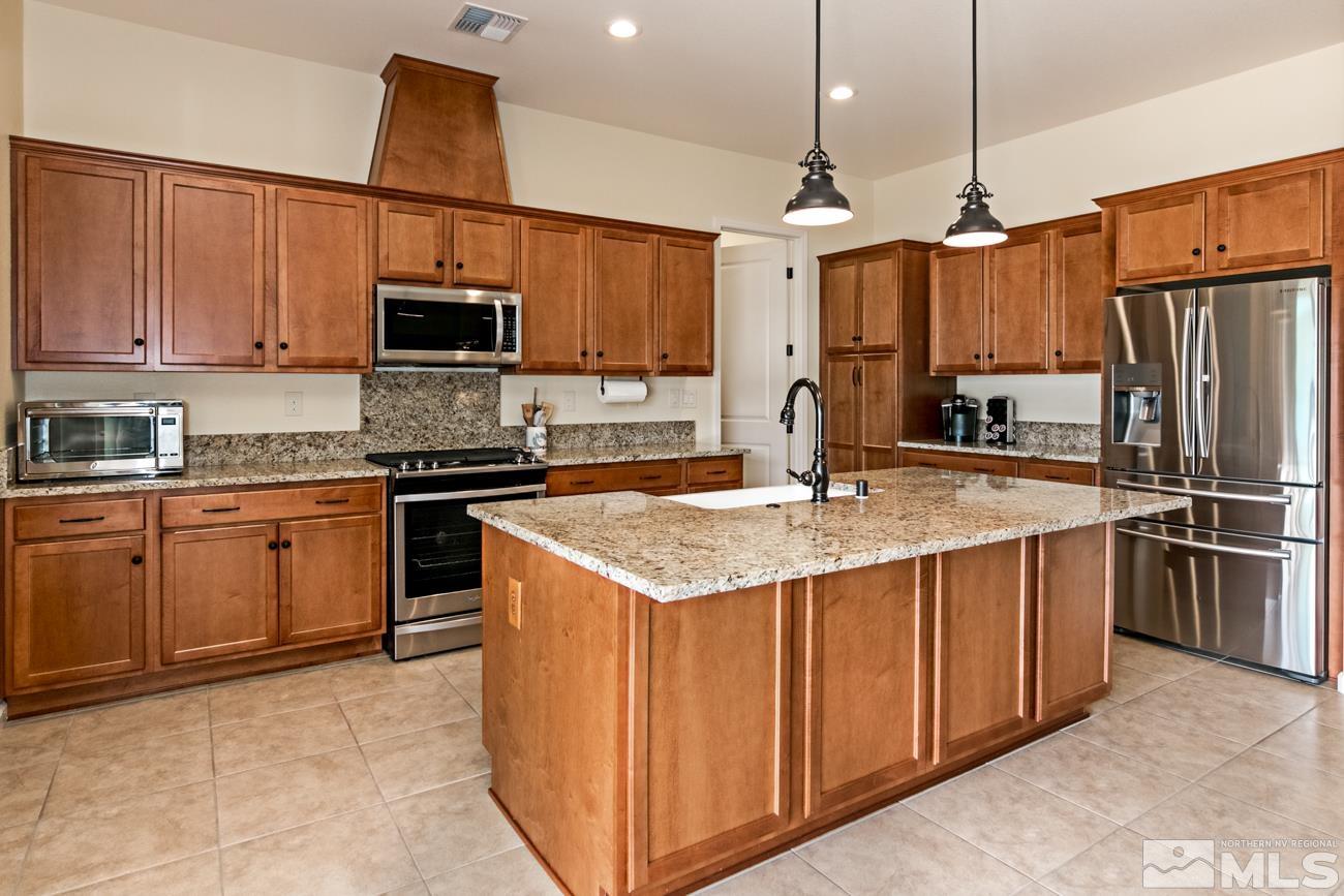 1992 Phaethon Lane Reno, NV 89521 - Photo 5 of 37 a kitchen with stainless steel appliances granite countertop a sink a stove and a refrigerator