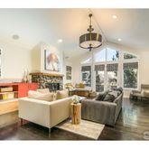 a living room with furniture kitchen view and a large window