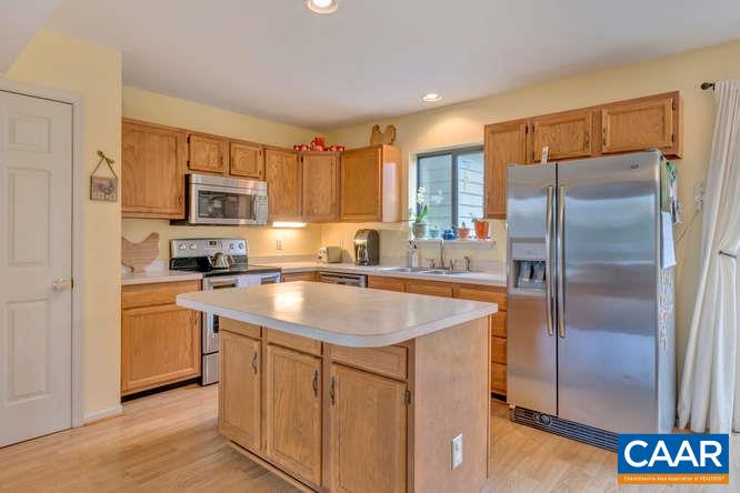 1134 Amber Ridge Road Charlottesville, VA 22901 - Photo 8 of 34 a kitchen with stainless steel appliances granite countertop a refrigerator a sink and a stove