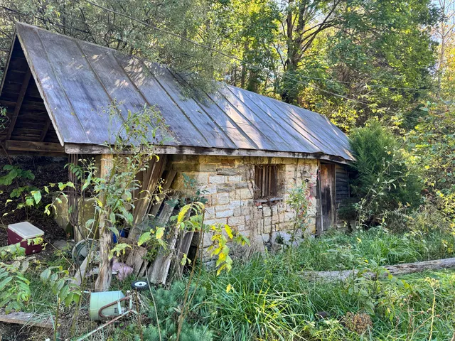 a aerial view of a house with table and chairs under an umbrella