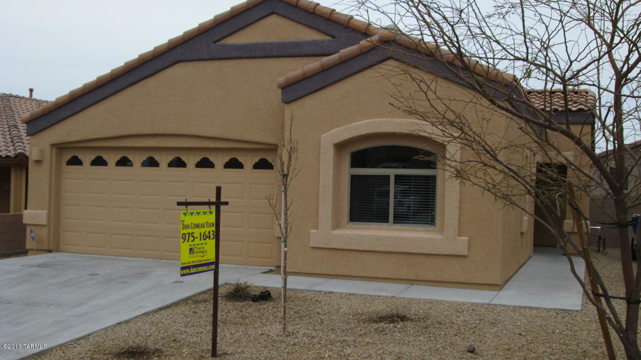 10855 East New Rock Ridge Drive Vail, AZ 85641 - Photo 1 of 34 a front view of a house with a garage