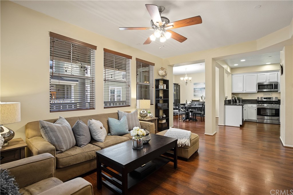 12 Valmont Way Ladera Ranch, CA 92694 - Photo 1 of 1 a living room with furniture and a large window with kitchen view