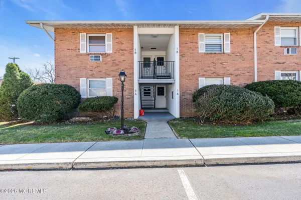 a front view of a house with a garden and a yard