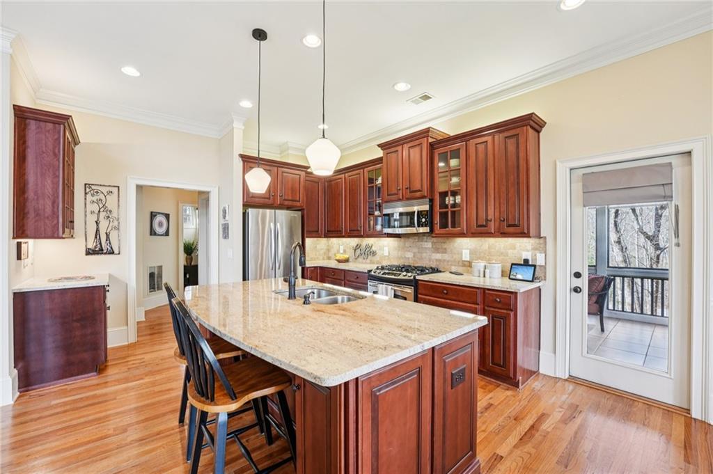 29 Red Trillium Ridge Big Canoe, GA 30143 - Photo 15 of 76 a kitchen with a stove a refrigerator a sink dishwasher with a dining table and chairs