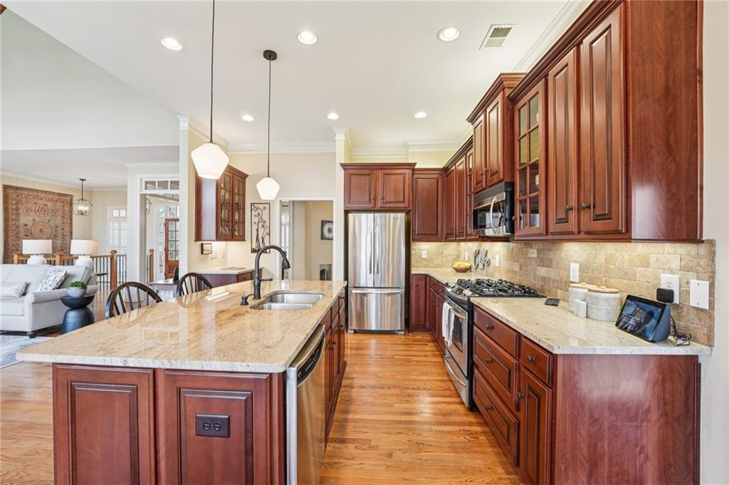 29 Red Trillium Ridge Big Canoe, GA 30143 - Photo 16 of 76 a kitchen with kitchen island granite countertop a sink a counter top stainless steel appliances and cabinets