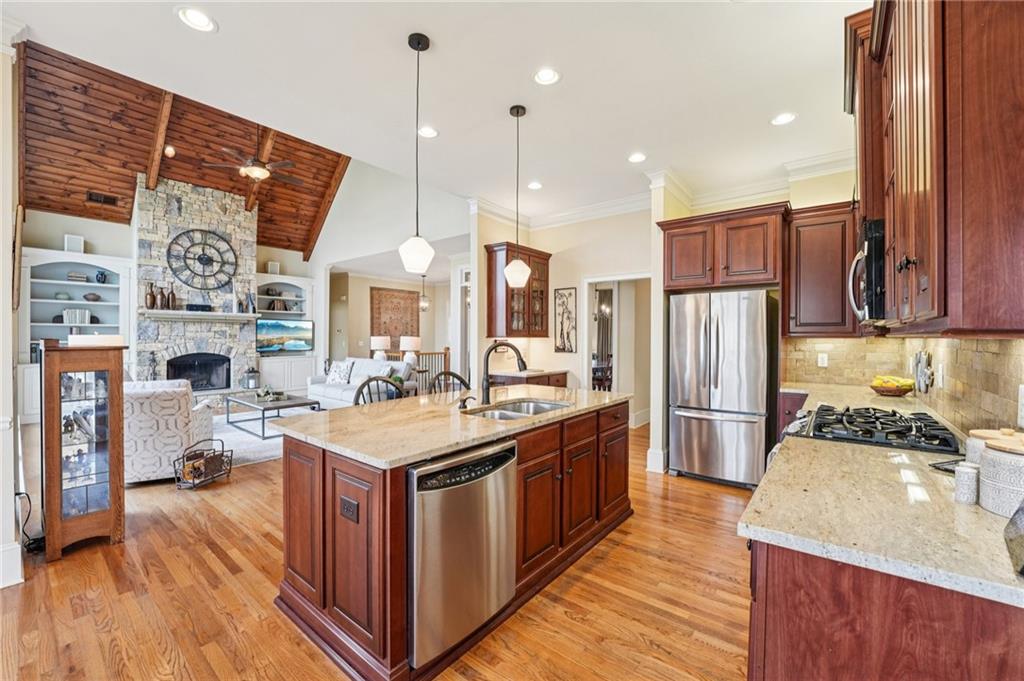 29 Red Trillium Ridge Big Canoe, GA 30143 - Photo 17 of 76 a kitchen with stainless steel appliances granite countertop a stove a sink dishwasher and a refrigerator with wooden floor