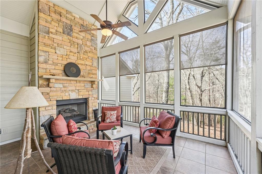 29 Red Trillium Ridge Big Canoe, GA 30143 - Photo 21 of 76 a living room with furniture a fireplace and a floor to ceiling window
