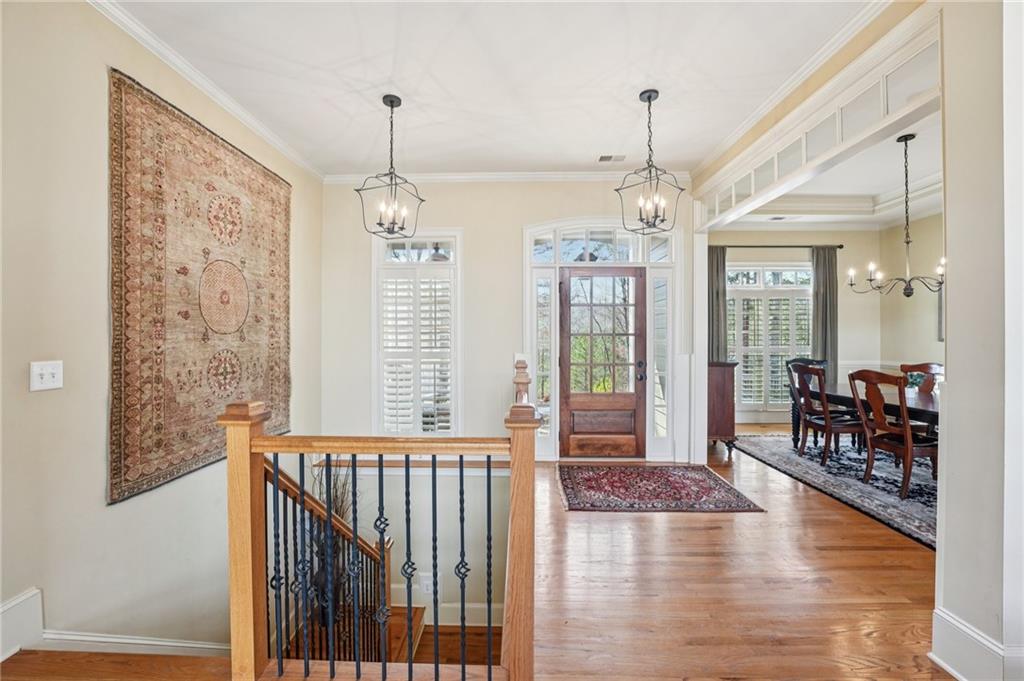 29 Red Trillium Ridge Big Canoe, GA 30143 - Photo 3 of 76 a dining room with wooden floor windows and a chandelier