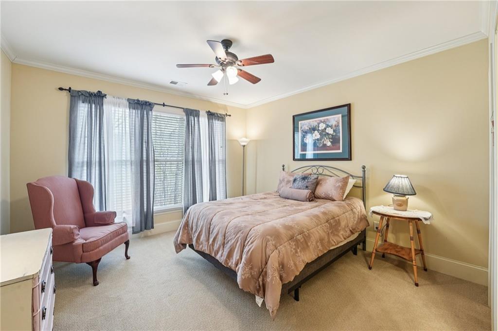 29 Red Trillium Ridge Big Canoe, GA 30143 - Photo 35 of 76 a bedroom with a bed and a chandelier