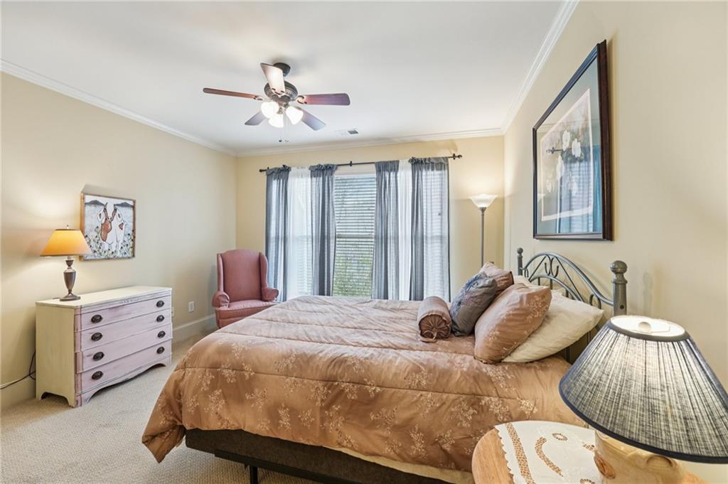 29 Red Trillium Ridge Big Canoe, GA 30143 - Photo 36 of 76 a bedroom with a bed and a chandelier