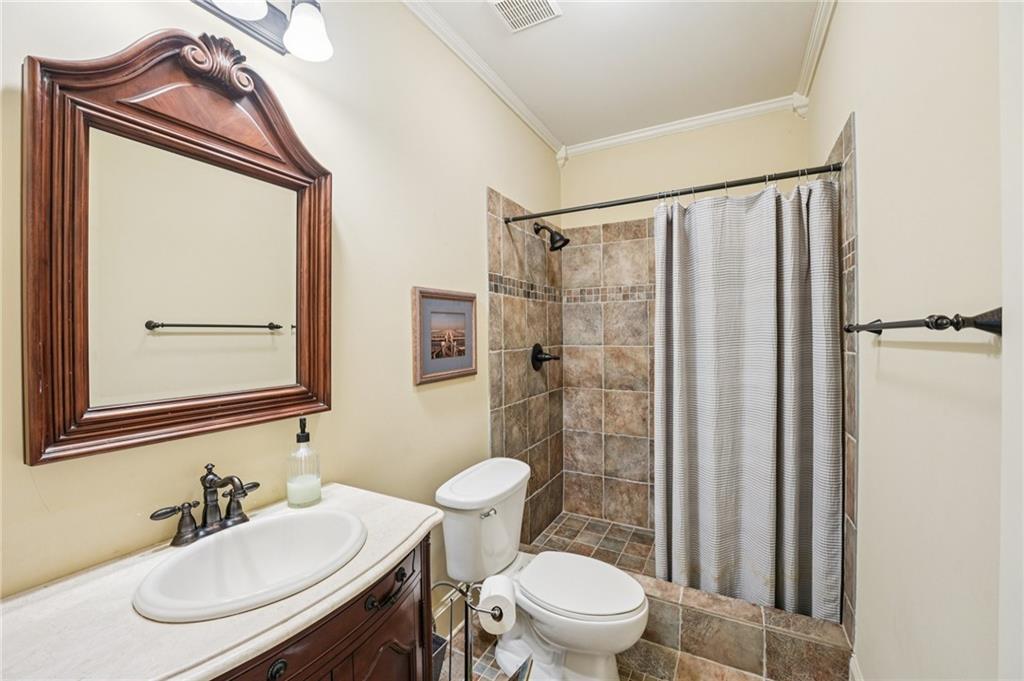 29 Red Trillium Ridge Big Canoe, GA 30143 - Photo 44 of 76 a bathroom with a sink a toilet and shower