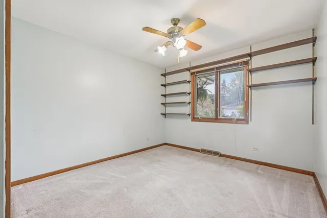 a bathroom with a granite countertop toilet a sink and a mirror