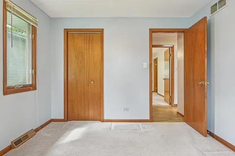 a view of a porch with furniture and wooden floor
