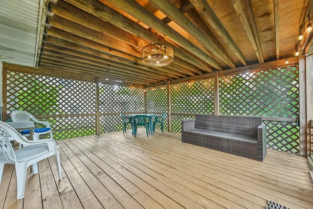 a balcony with view of wooden floor and fence