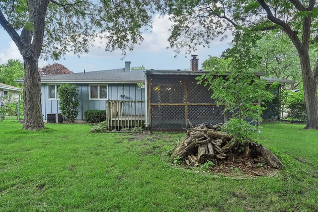 a view of house with backyard