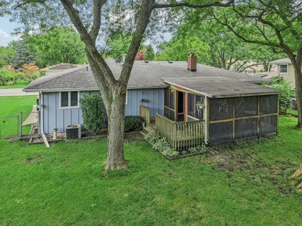 an aerial view of a house with a garden and street view