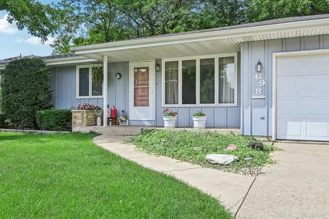 an aerial view of residential houses with outdoor space and trees